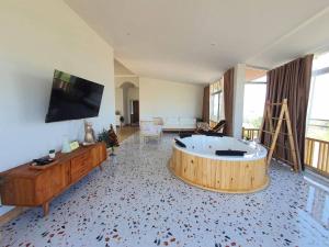 a large living room with a tub in the middle of it at Jacuzzi mine hills in Ban Mai