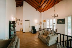 a living room with a couch and a chandelier at SkyPort Villa Negombo in Negombo