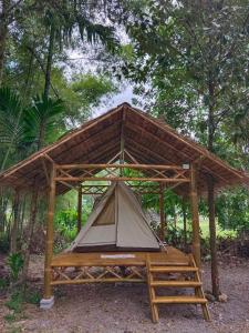 a tent in a wooden structure in the woods at Paivana Khaosok Village in Khao Sok