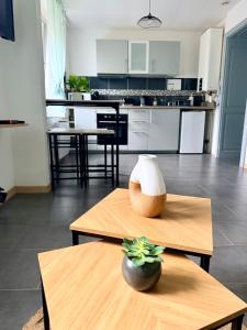 a kitchen with a table with a vase on it at Très bel appartement au cœur des Vosges in Saulcy-sur-Meurthe