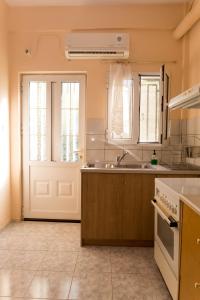 a kitchen with a sink and a white door at Adam's House in Tríkala +27 photos