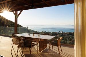 a table and chairs on a balcony with a view at Thaleri Villa in Pyrgi