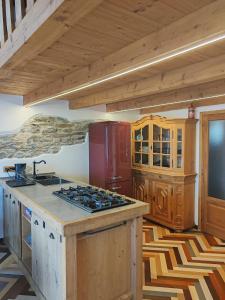 a kitchen with a stove and a red refrigerator at Chalet La montagne enchantée in San Damiano Macra +23 photos