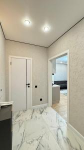 an empty room with a marble floor and a door at Expo New Life Astana in Astana