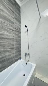 a bathroom with a bath tub with a shower at Expo New Life Astana in Astana