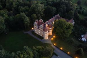 an aerial view of a mansion with lights at Schloßhotel Althörnitz in Hörnitz