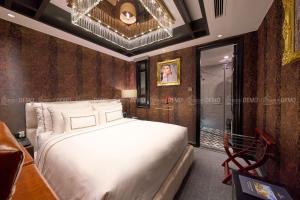 Postel nebo postele na pokoji v ubytování The Haron Hanoi Boutique Hotel