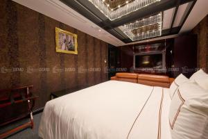 Postel nebo postele na pokoji v ubytování The Haron Hanoi Boutique Hotel