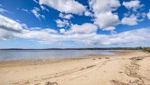 a view of a sandy beach with a cloudy sky at Bay House 95 by the BnB Collection in Albany