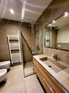 a bathroom with a shower and a sink and a toilet at Casa Diletta in Prade