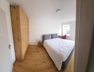 a bedroom with a bed and a wooden floor at Casa Diletta in Prade