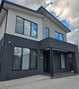a large house with black and white at Maruve Guesthouse Plus- Modern Stay near Melb Airport 12 min in Melbourne +32 photos