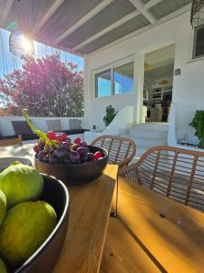 a table with two bowls of fruit on top of it at Magia's Residence in Naousa