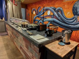 a kitchen counter with a painting on the wall at Best Western Linko Aubagne in Aubagne
