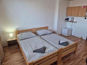 a bedroom with a bed with two pillows on it at Penzión Tina in Prešov