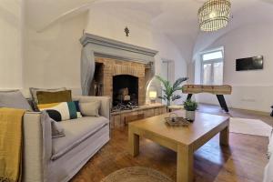a living room with a couch and a fireplace at La Veore in Chabeuil