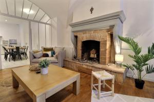 a living room with a fireplace and a table at La Veore in Chabeuil