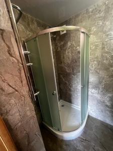 a shower in a bathroom with a glass door at Котедж GLORIA будинок повністю in Yaremche +16 photos