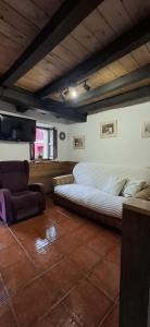 a bedroom with a large bed and a couch at Casa Almarex in Gobiendes