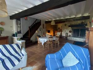a living room with a table and chairs at Les rives enchantées in Courçay