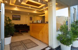 a lobby with a wooden door and a counter at Heryk Hillview Hotel in Dharamshala