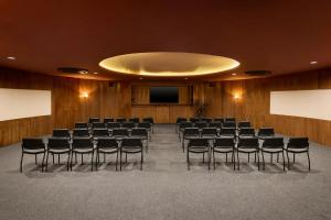 a conference room with chairs and a screen at The Brown, Guatape, Autograph Collection in Guatapé
