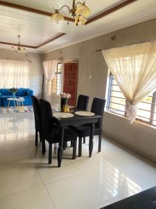 a dining room with a black table and chairs at Executive house in Lusaka