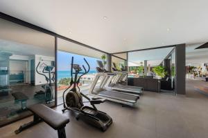 a gym with cardio equipment in a house at Villa Veha, SPA, Fitness and Games room in Amphoe Koh Samui