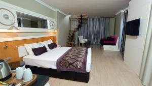 a hotel room with a bed and a dining room at Serenis Hotel in Side +40 photos