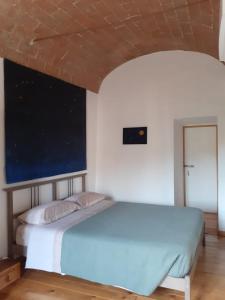 a bedroom with a large bed in a room at Casa Iolanda in Siena