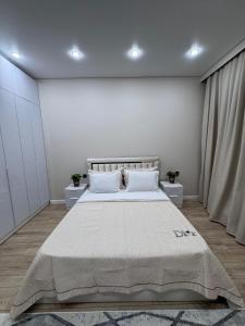 Ένα ή περισσότερα κρεβάτια σε δωμάτιο στο Апартаменты в ЖК 4YOU