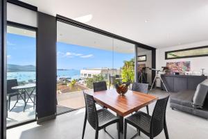 a dining room with a table and chairs at Villa Veha, SPA, Fitness and Games room in Amphoe Koh Samui