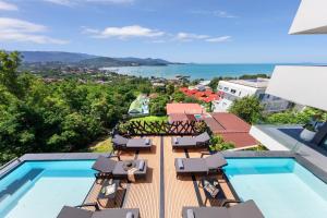 a view of a resort with a pool and chairs at Villa Veha, Koh Samui Resort & Free Spa, Fitness, Massage room, Espace game in Koh Samui
