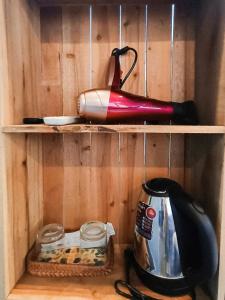 a tea kettle and an umbrella on a shelf at Lucky Motel - Self Checkin in Hanoi