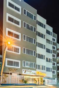 a tall white building with a street light in front of it at Hotel Vaari Vista By Bestinn Leisure in Bengaluru