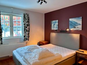 a bedroom with a bed and a window at Apartments Klövsjöfjäll in Klövsjö +34 photos