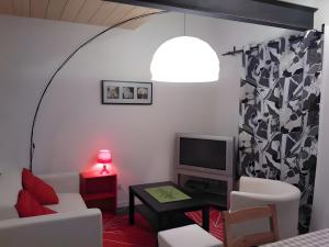 a living room with a white couch and a tv at Gites Gayet in Fours