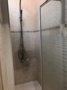 a shower with a glass door in a bathroom at Gites Gayet in Fours