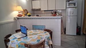 a kitchen with a table with a laptop on it at La Bastide in Sanary-sur-Mer