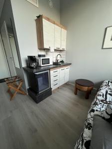 a kitchen with a microwave and a bed in a room at Inari Camping & Resort in Inari