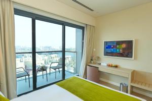 TV a/nebo společenská místnost v ubytování Pavilion Hotel Al Jaddaf - Former Citadines Culture Village