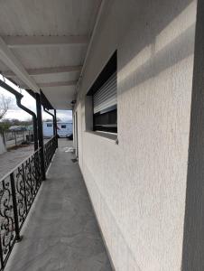 a balcony with a window on the side of a building at Râului 43 in Ocna-Mureşului