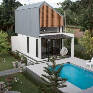 a small house with a swimming pool in the backyard at Cosy Pool Villa at Khaoyai in Nong Nam Daeng