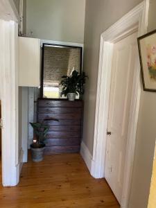 a hallway with a window and two potted plants at The Gilded Hare in Moonta in Moonta
