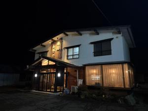 a house at night with its lights on at 旅館おぎた Ryokan Ogita - near Shiraoi Station in Shiraoi