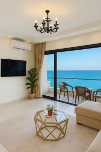 a living room with a view of the ocean at ALEX HOMES - Gleem Luxury Apartments with Direct Sea View in Alexandria
