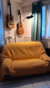 a bedroom with guitars on the wall and a bed at La Bastide in Sanary-sur-Mer