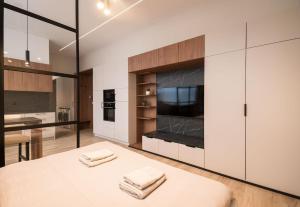 une cuisine avec des armoires blanches et une table avec deux serviettes dans l'établissement Apartments Ružomberok 204, à Ružomberok