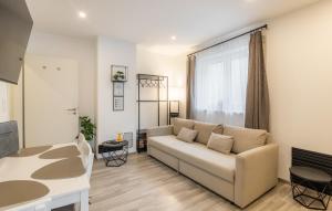 a living room with a couch and a table at Secret Collection Thermenresort in Frauenkirchen