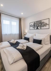 a bedroom with two beds with towels on them at Secret Collection in Frauenkirchen